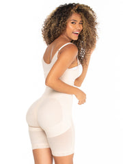 afro latina curvy laughing looking back wearing mid compression beige faja 